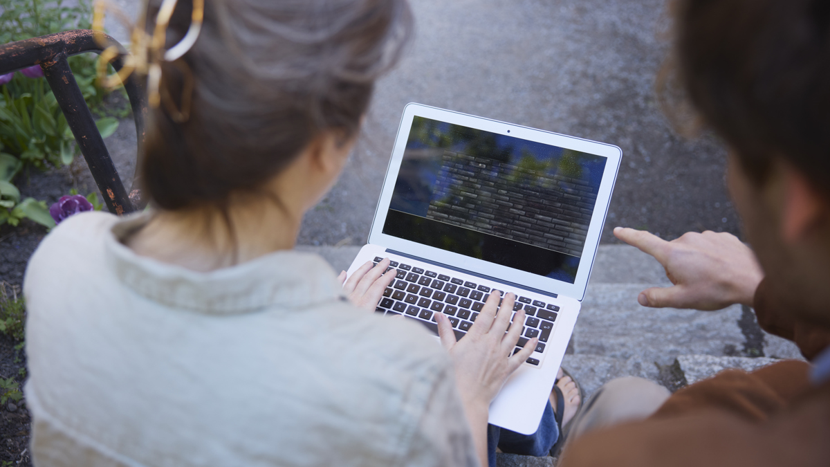 Två personer tittar på en datorskärm.